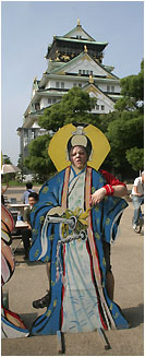 nick as a geisha (or something like that) in front of osaka castle